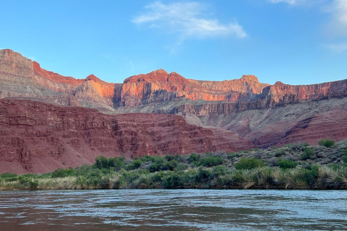 Red rock canyon with river and blue sky.