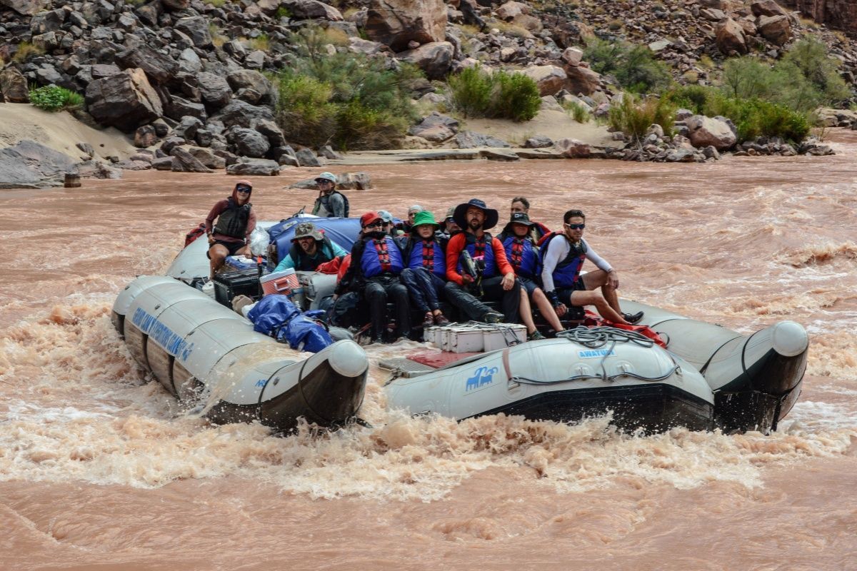 A group of people are riding a raft down a river.