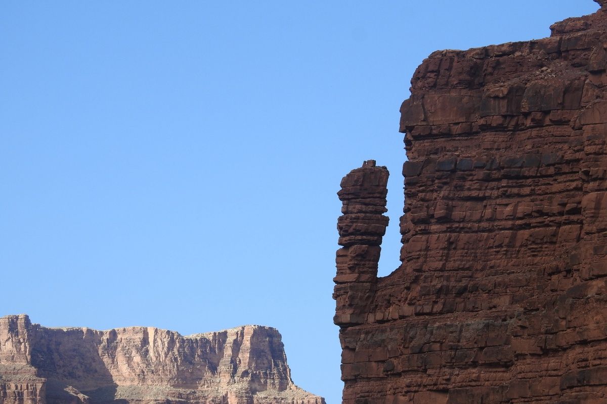 A rock formation with a blue sky in the background