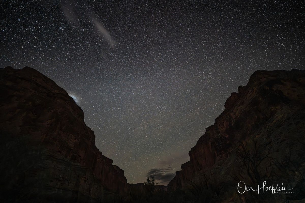 A night sky with a lot of stars and mountains in the foreground