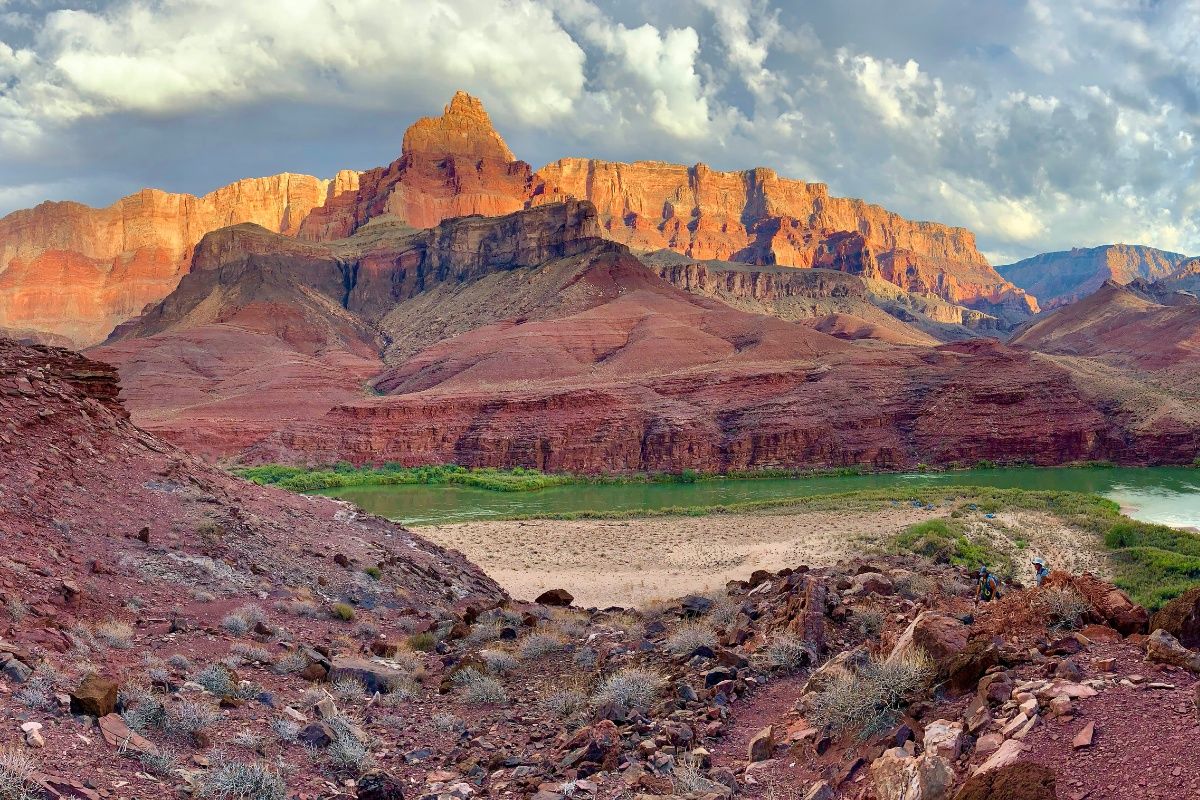 There is a mountain in the background and a river in the foreground.