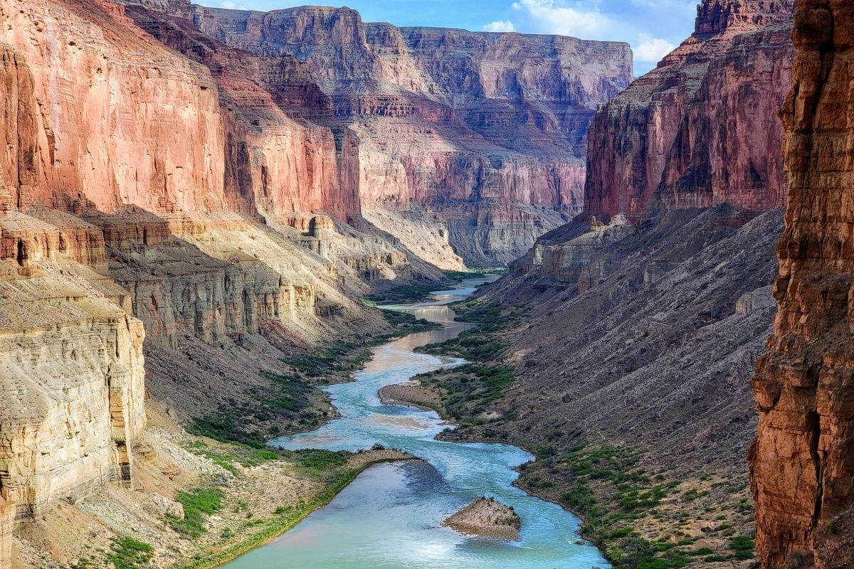 A river flowing through a canyon surrounded by rocks.