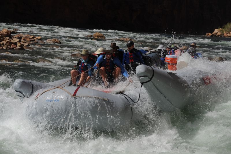 A group of people are rafting down a river
