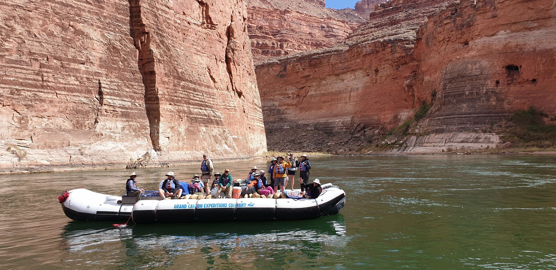 A group of people are on a boat that says ' nv ' on it