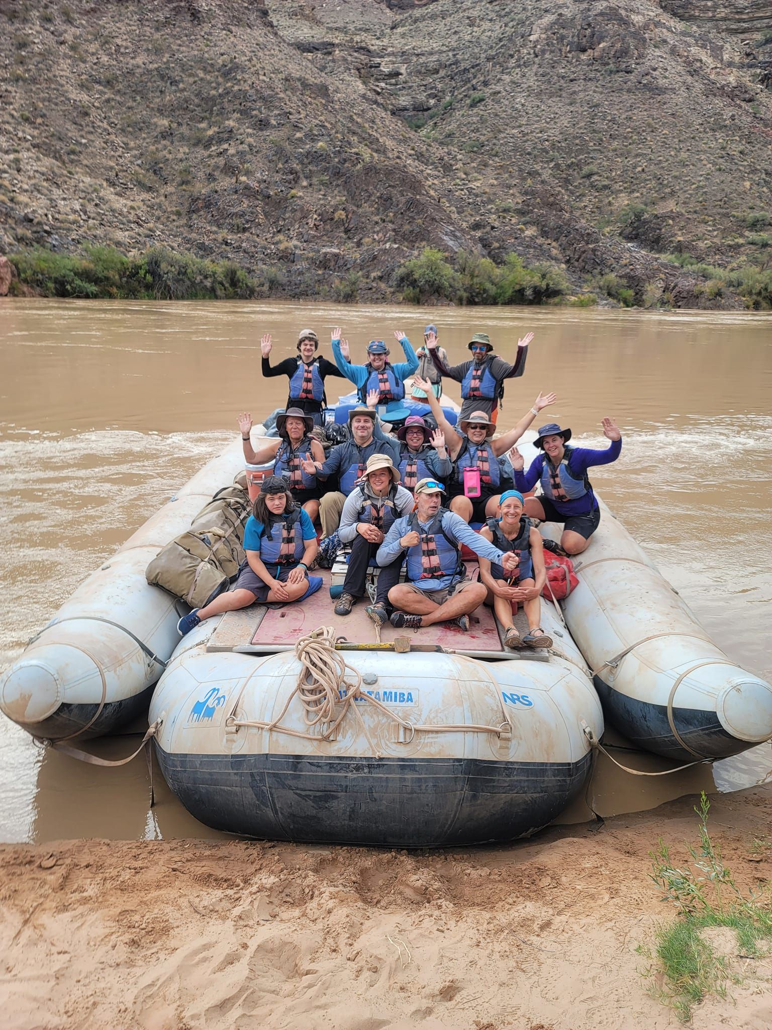 A group of people are posing for a picture on a raft
