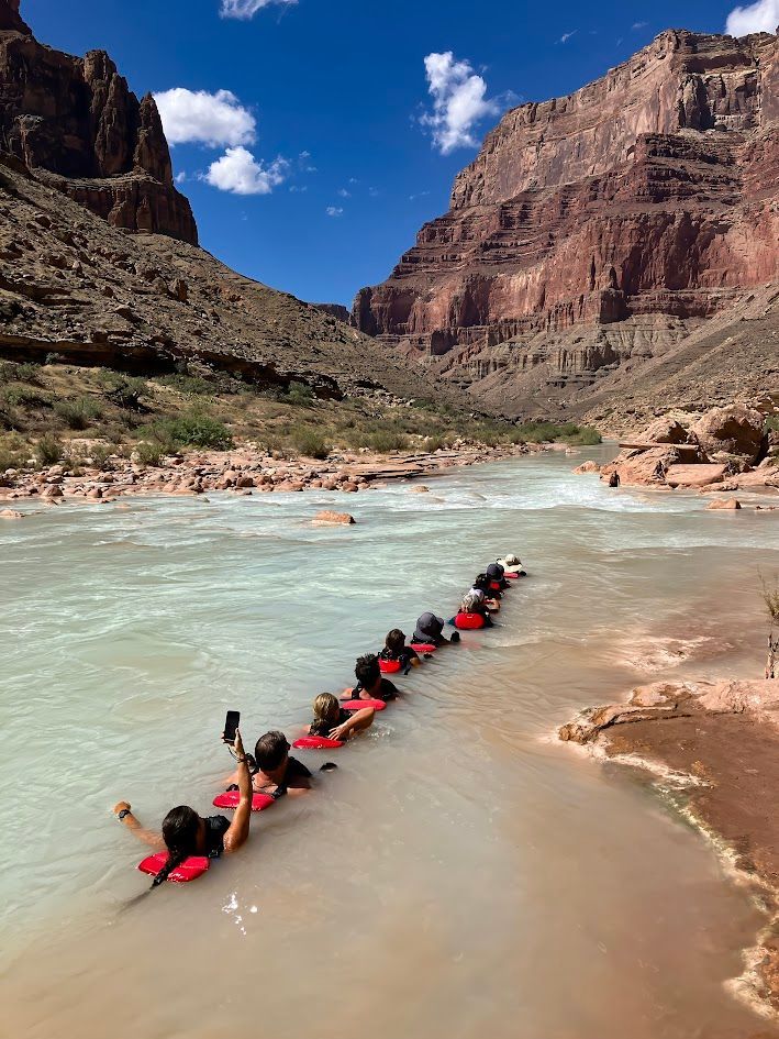 A group of people are floating down a river.