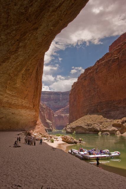 A canyon with a river and boats in it