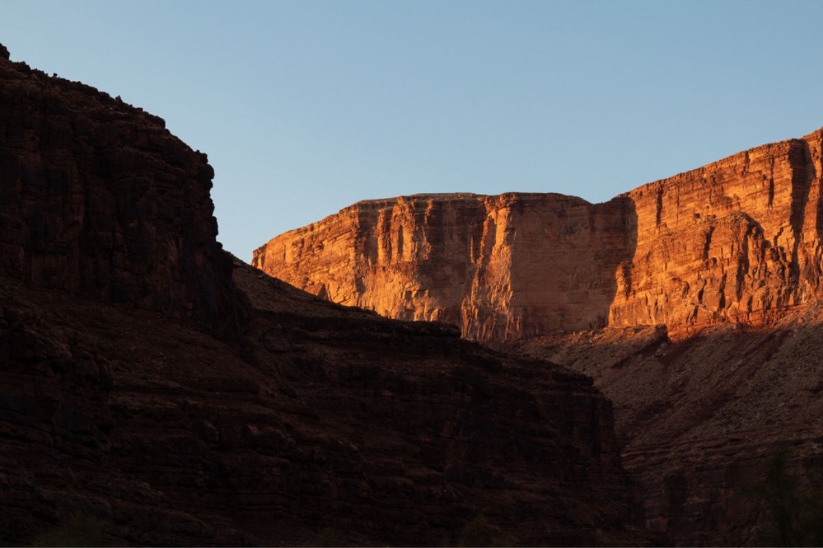 A mountain with a blue sky in the background