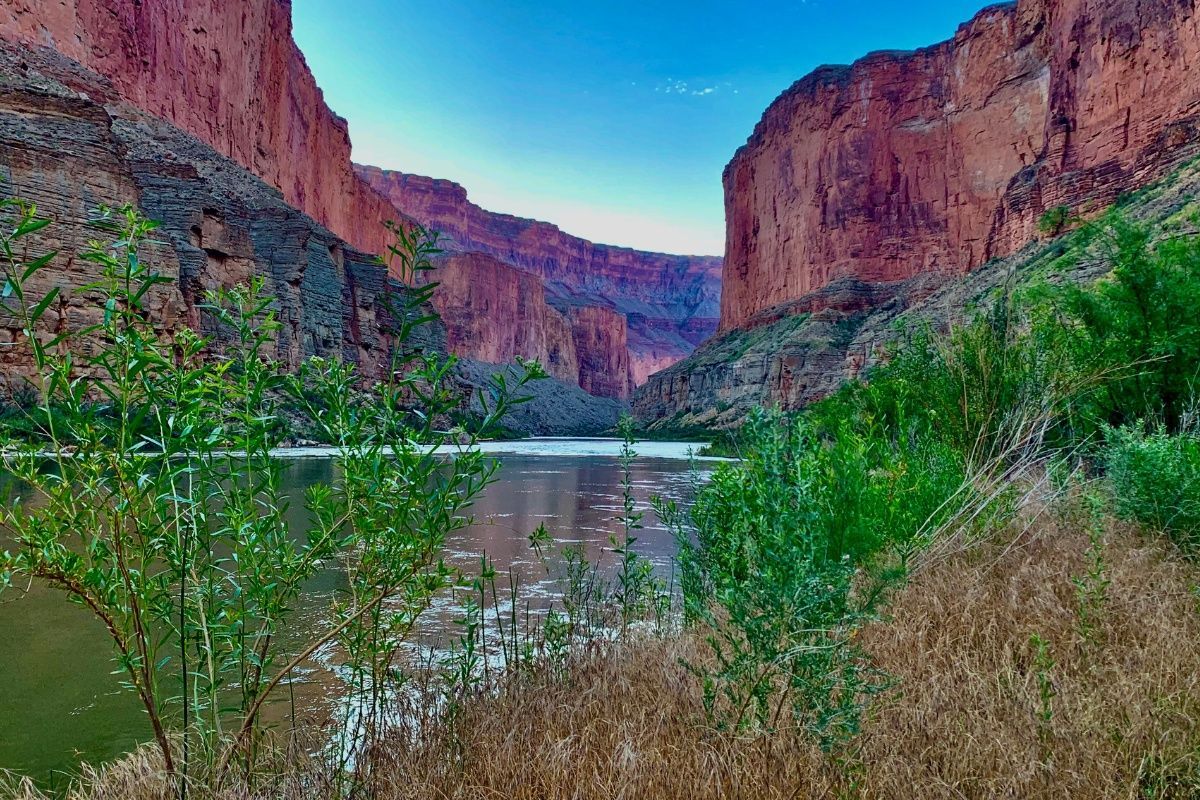 A river runs through a canyon between two mountains.
