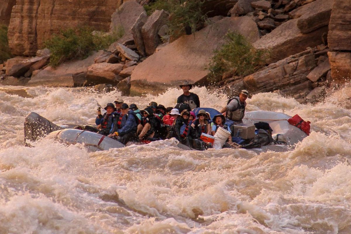A group of people are rafting down a river