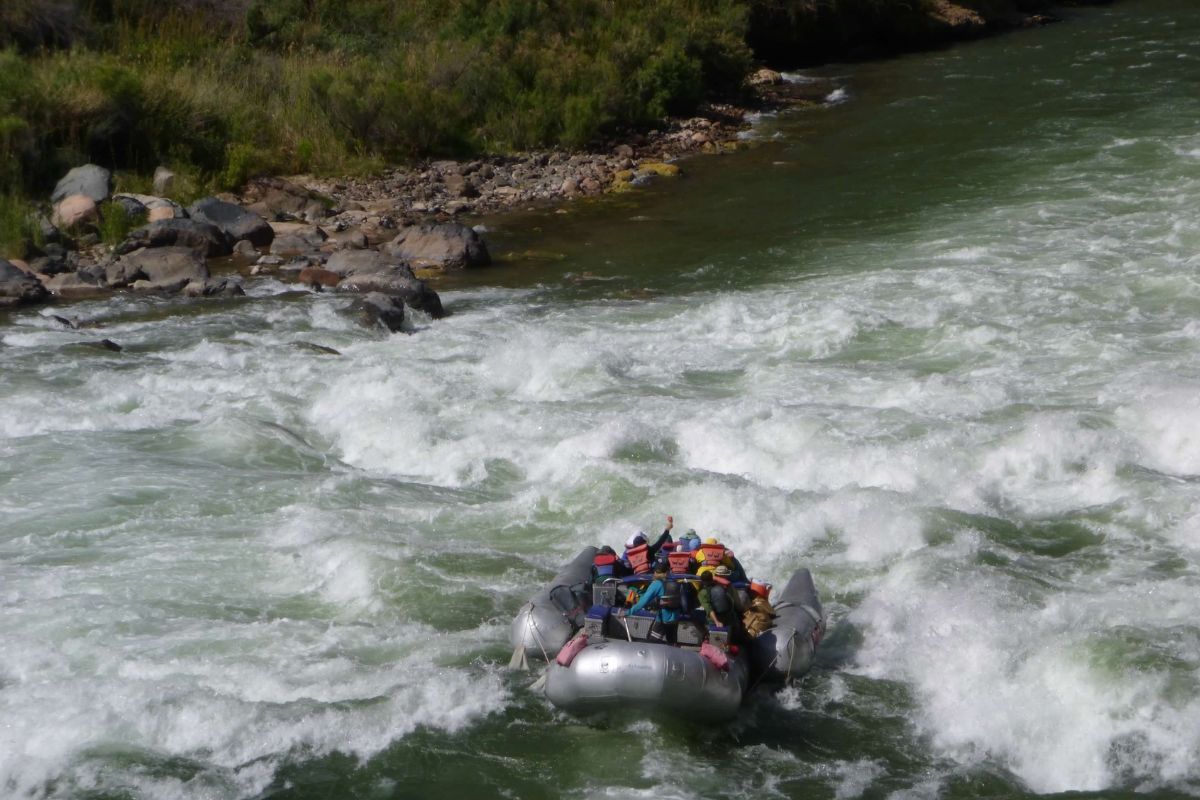 A group of people are rafting down a river