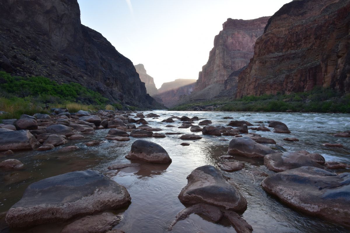 A river flowing through a canyon surrounded by rocks