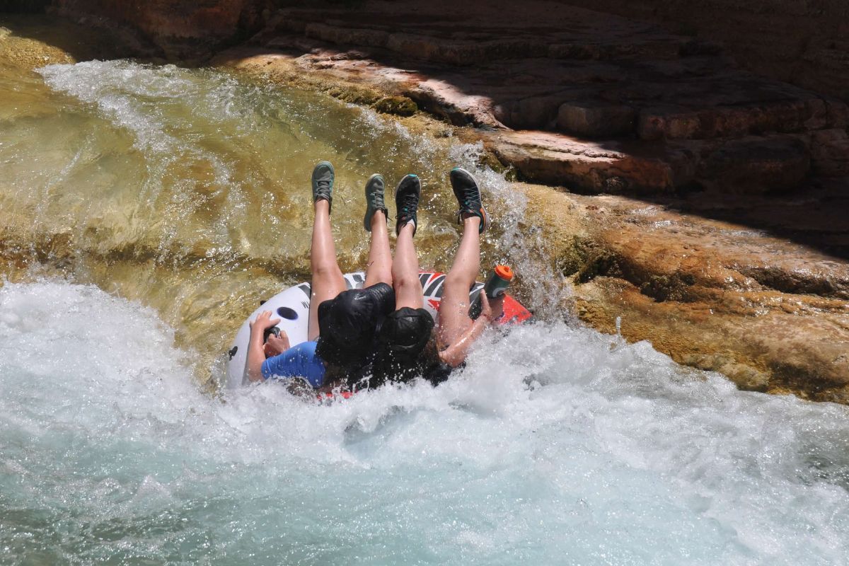 A person is floating down a river in a tube