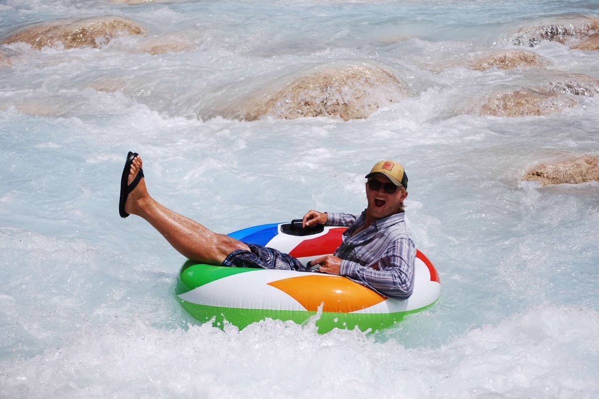 A man is floating on an inflatable raft in the water