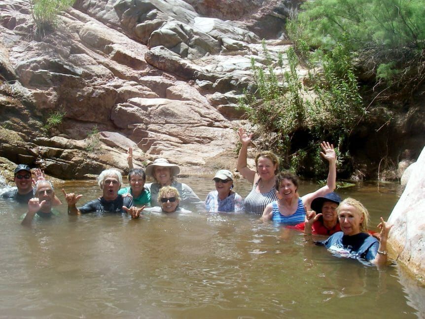 A group of people are posing for a picture in the water