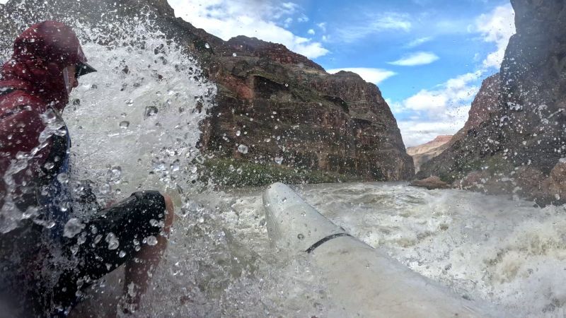 A person is riding a raft down a river.