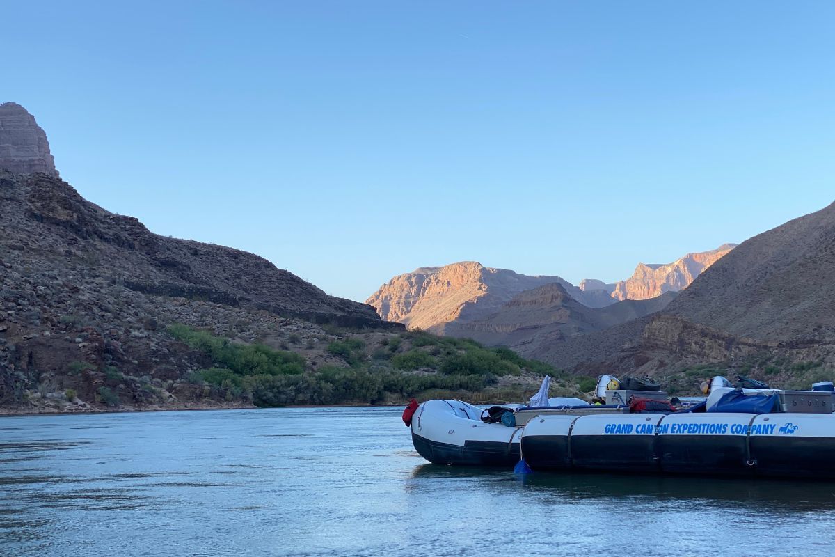 A boat on a lake with mountains in the background