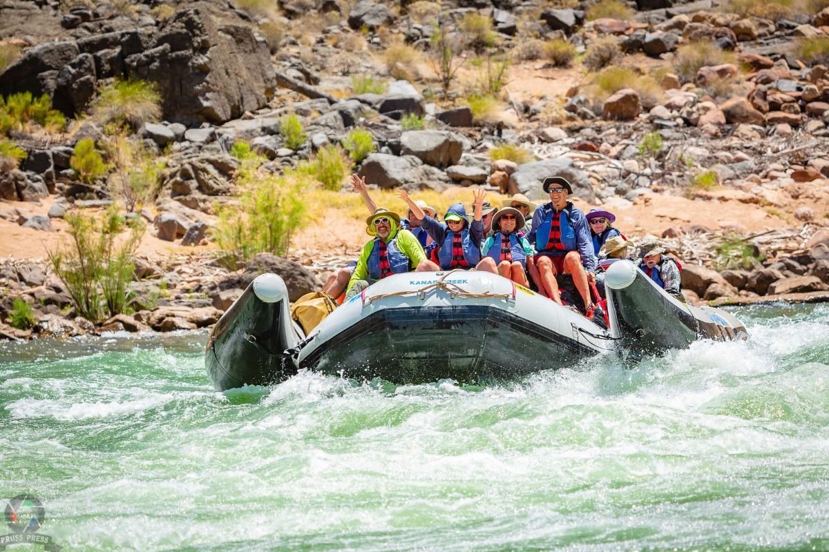 A group of people are rafting down a river