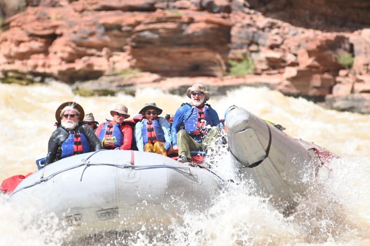 A group of people are riding a raft down a river