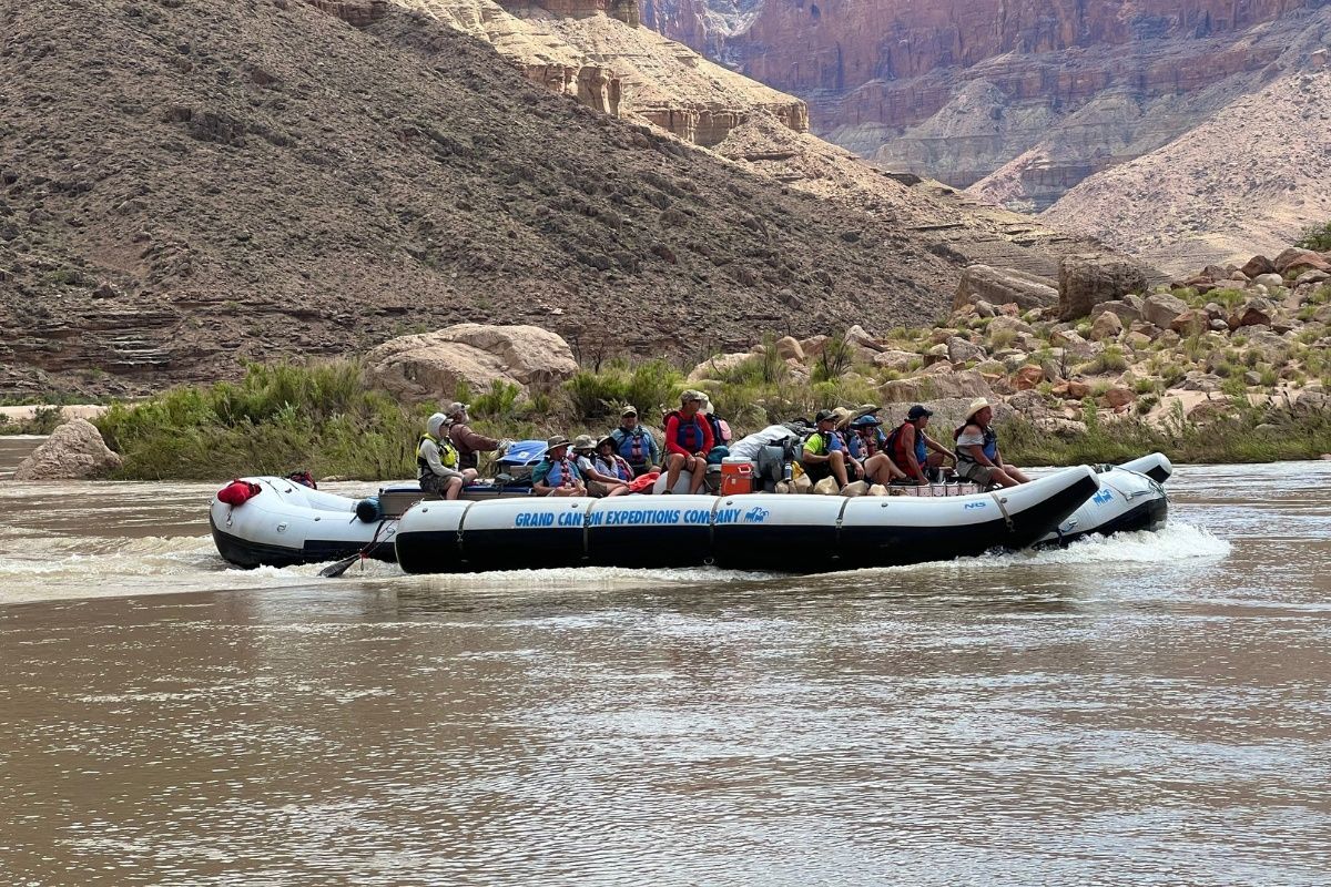 A group of people are riding a raft down a river.