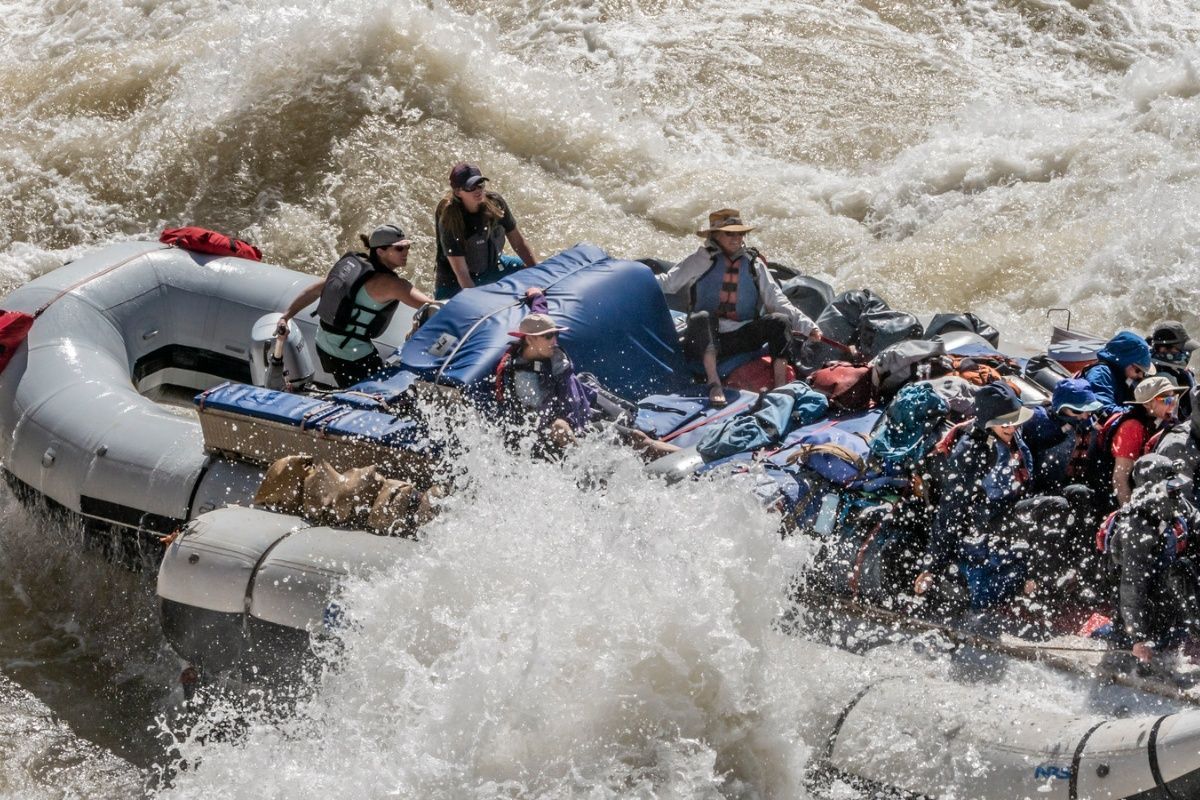 A group of people are rafting down a river