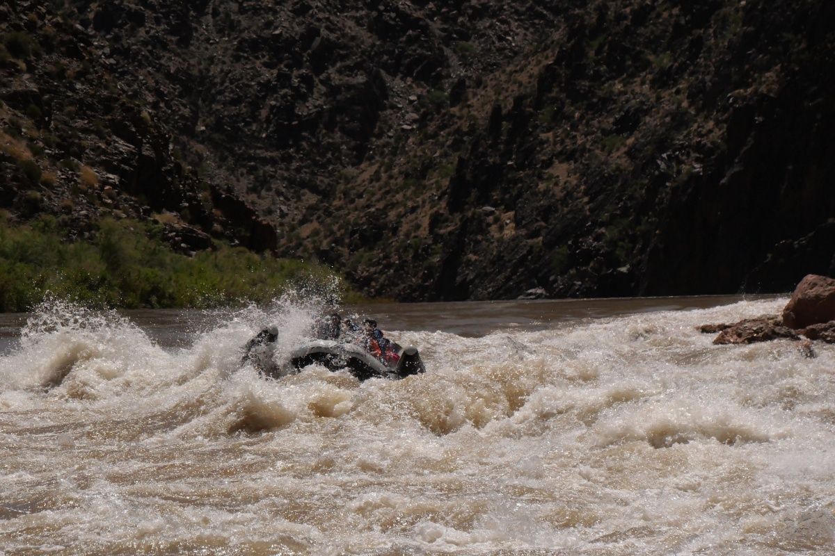 A person is floating down a river in a raft.