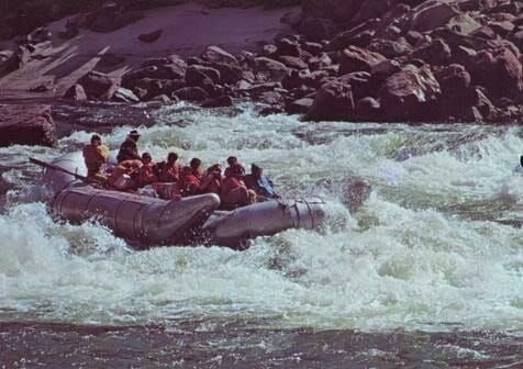 A group of people are rafting down a river.