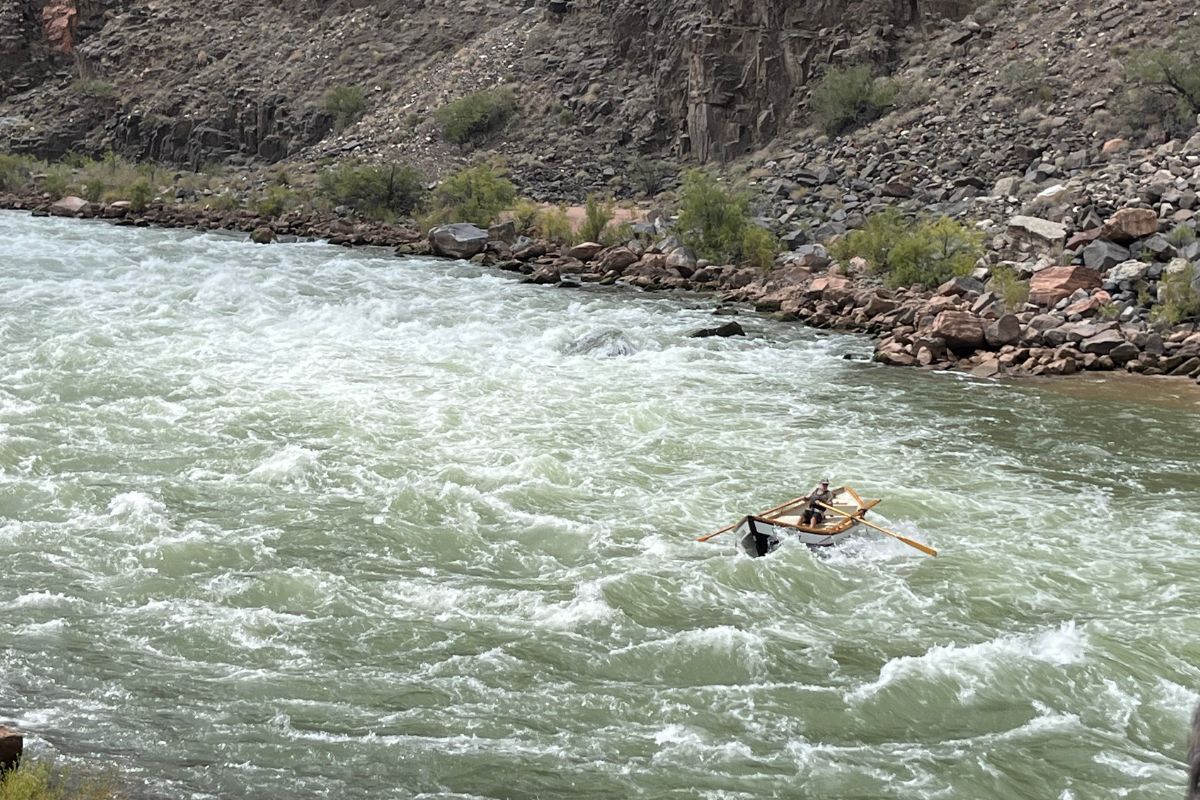 Rafting on a whitewater river, with rocky banks on either side.