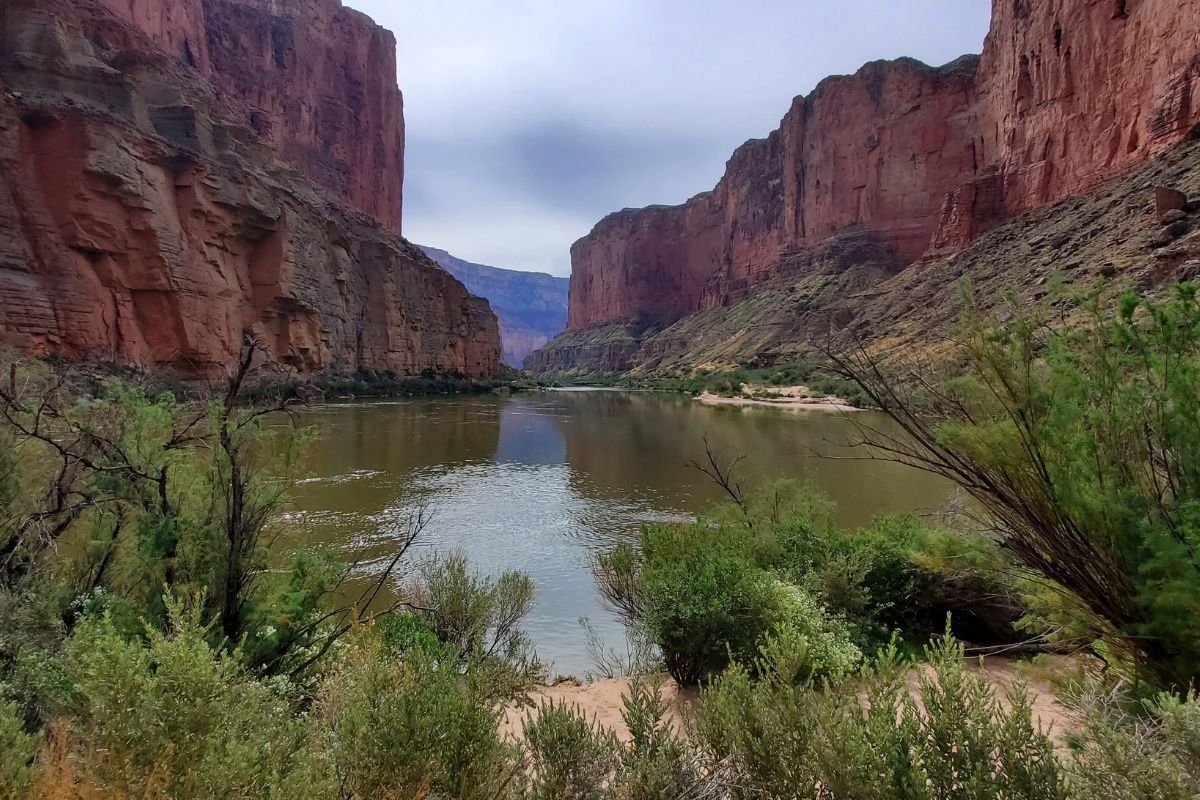 There is a river in the middle of a canyon surrounded by rocks.