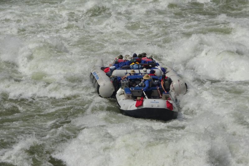 A group of people are rafting down a river