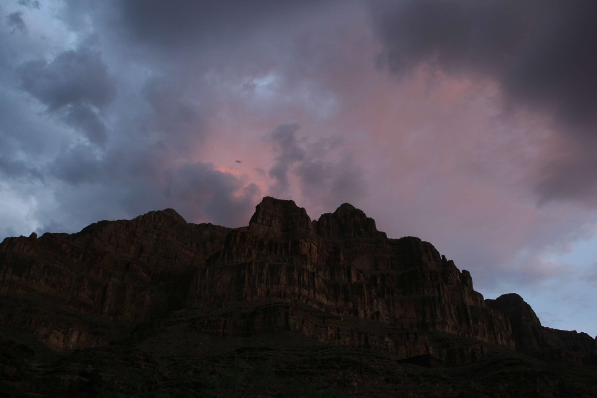 A mountain with a cloudy sky behind it