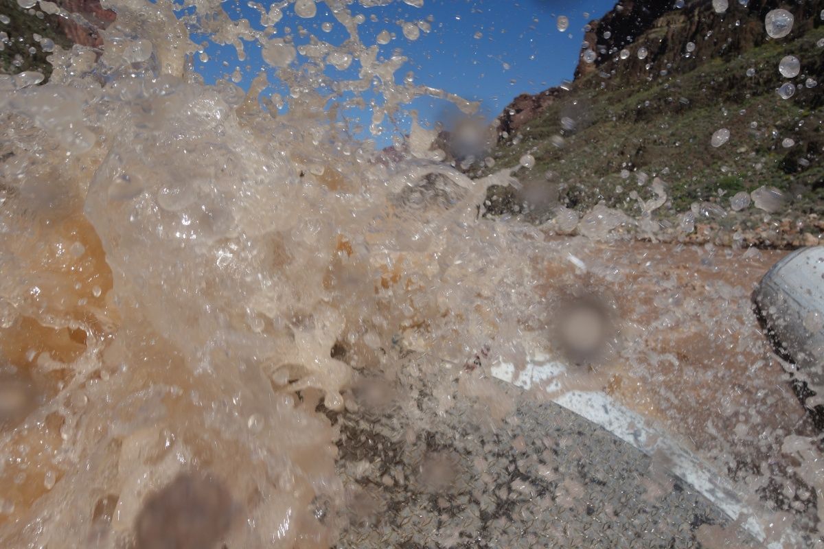 A close up of a splash of water on a rock.