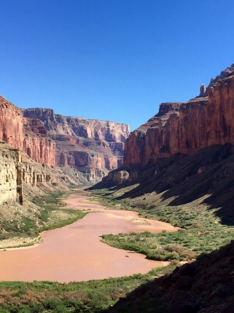 A river flowing through a canyon surrounded by mountains