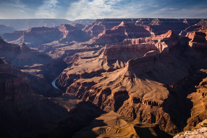 The grand canyon is a very large canyon with a river running through it.