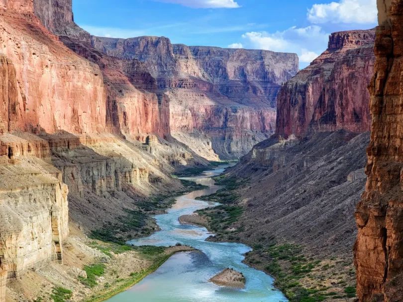 A river flowing through a canyon surrounded by rocks.