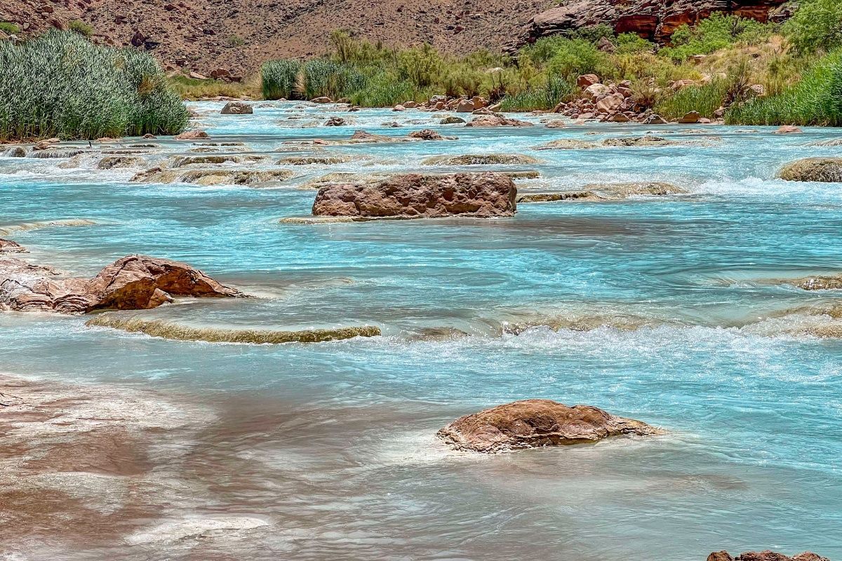 A river with a lot of water and rocks in it