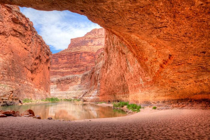 A view of a river through a cave in the desert.