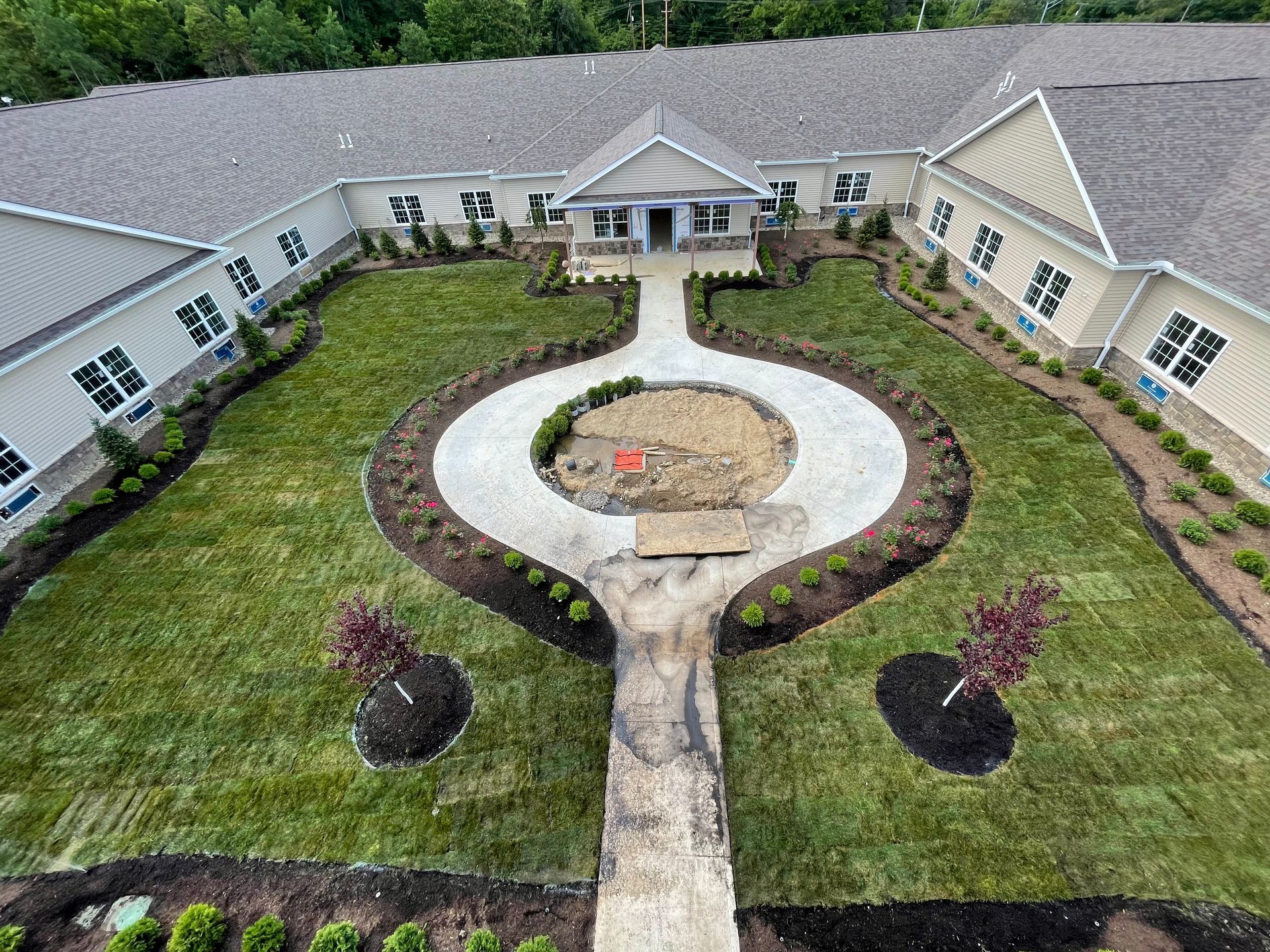 An aerial view of a large building with a circular walkway leading to it.