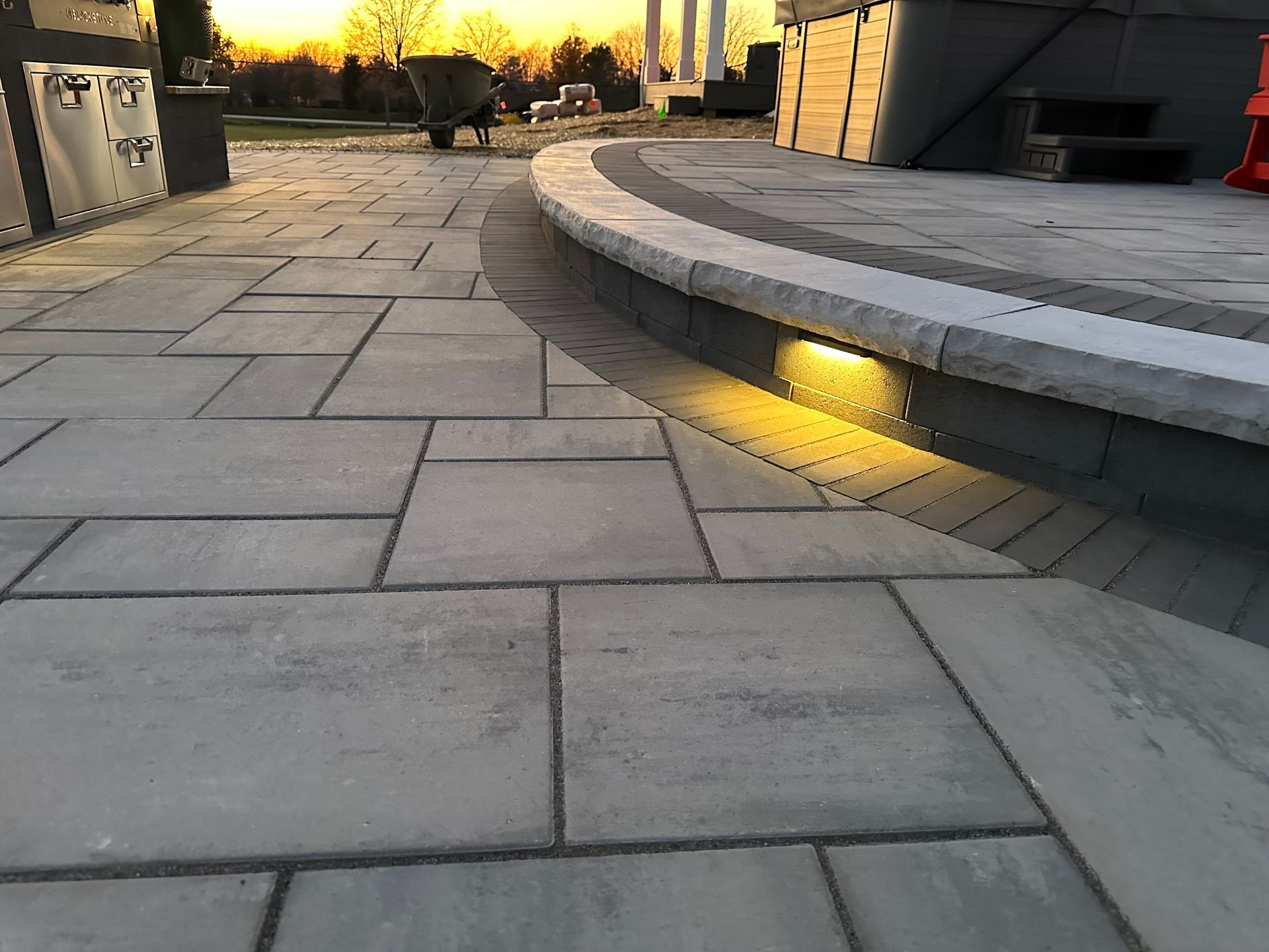 A close up of a brick walkway with a sunset in the background.