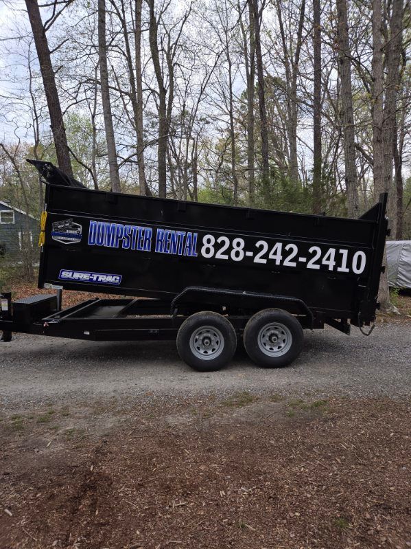 A large blue dumpster with its doors open on a white background.