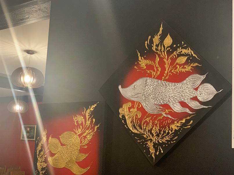 There is a painting of a fish on the wall.