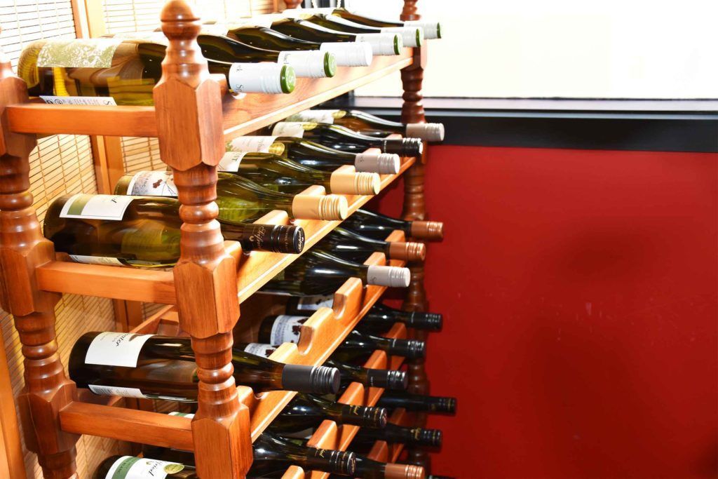A wooden wine rack filled with bottles of wine.