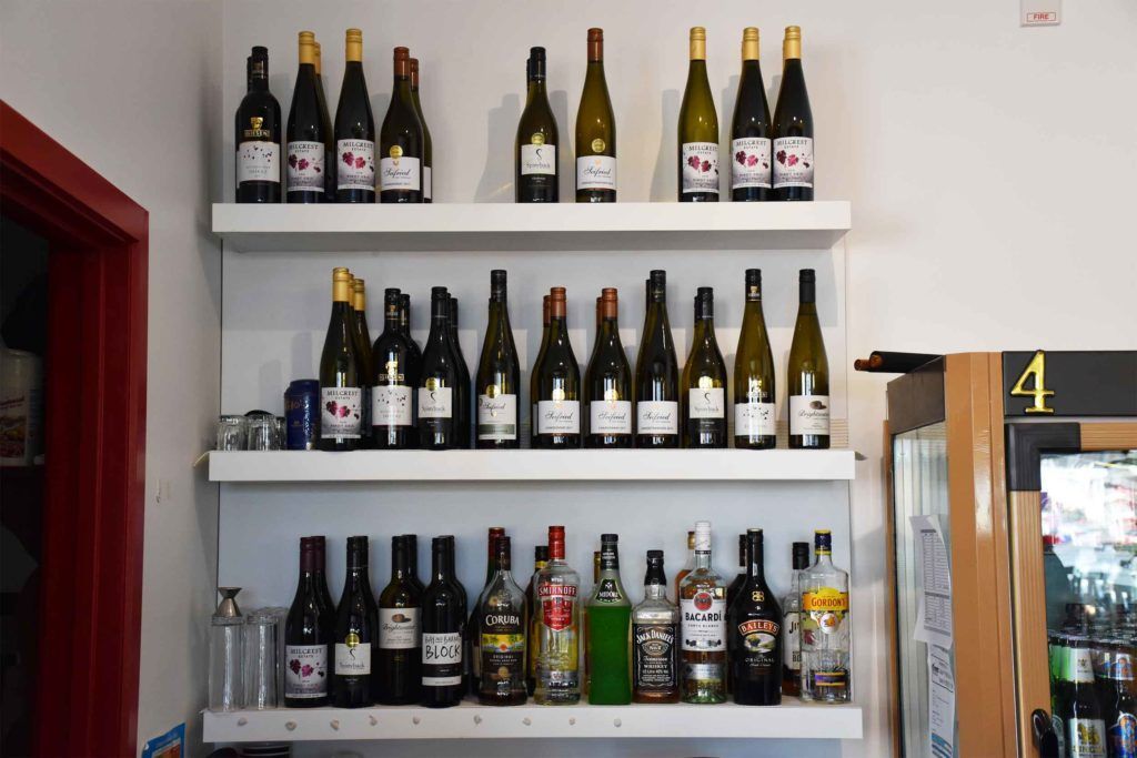 A shelf filled with bottles of wine and liquor