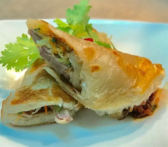 A close up of a sandwich on a white plate