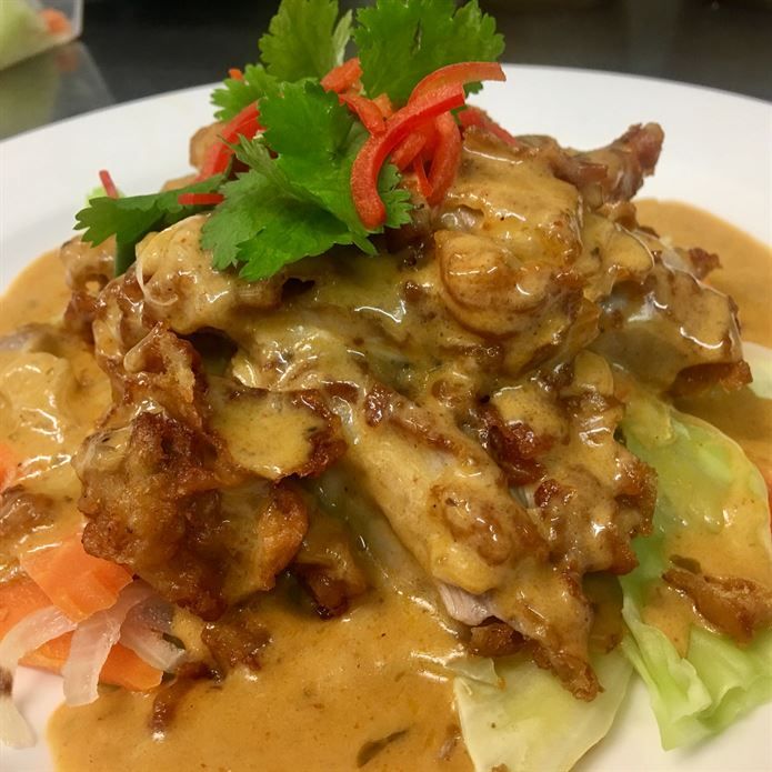 A close up of a plate of food with sauce and vegetables