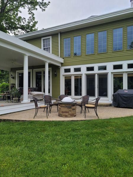 There is a fire pit in the backyard of a house.