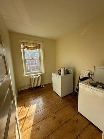 A laundry room with a washer and dryer and a window.