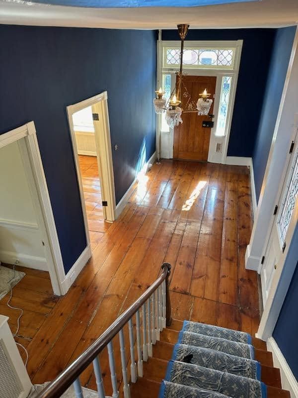 An aerial view of a hallway and stairs in a house.