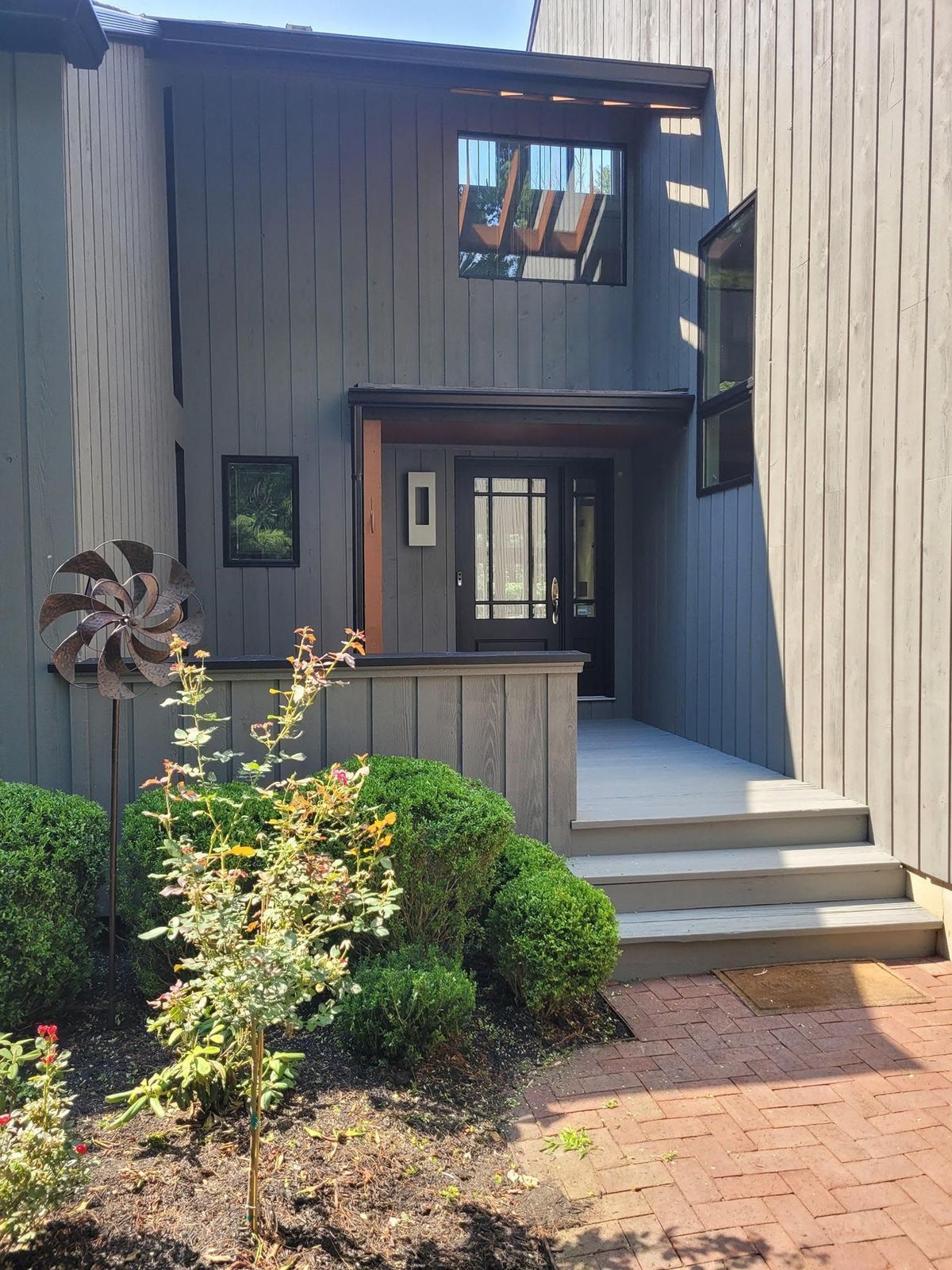 A house with a windmill in front of it