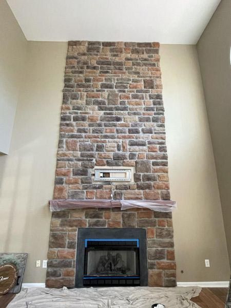 A fireplace in a living room with a brick wall